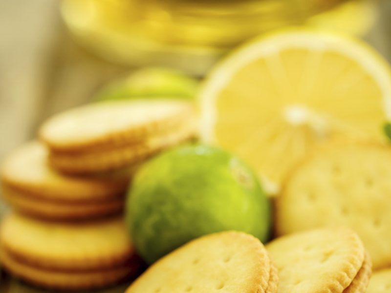 Delicious lemon pie with fresh lemons on dark background,top view